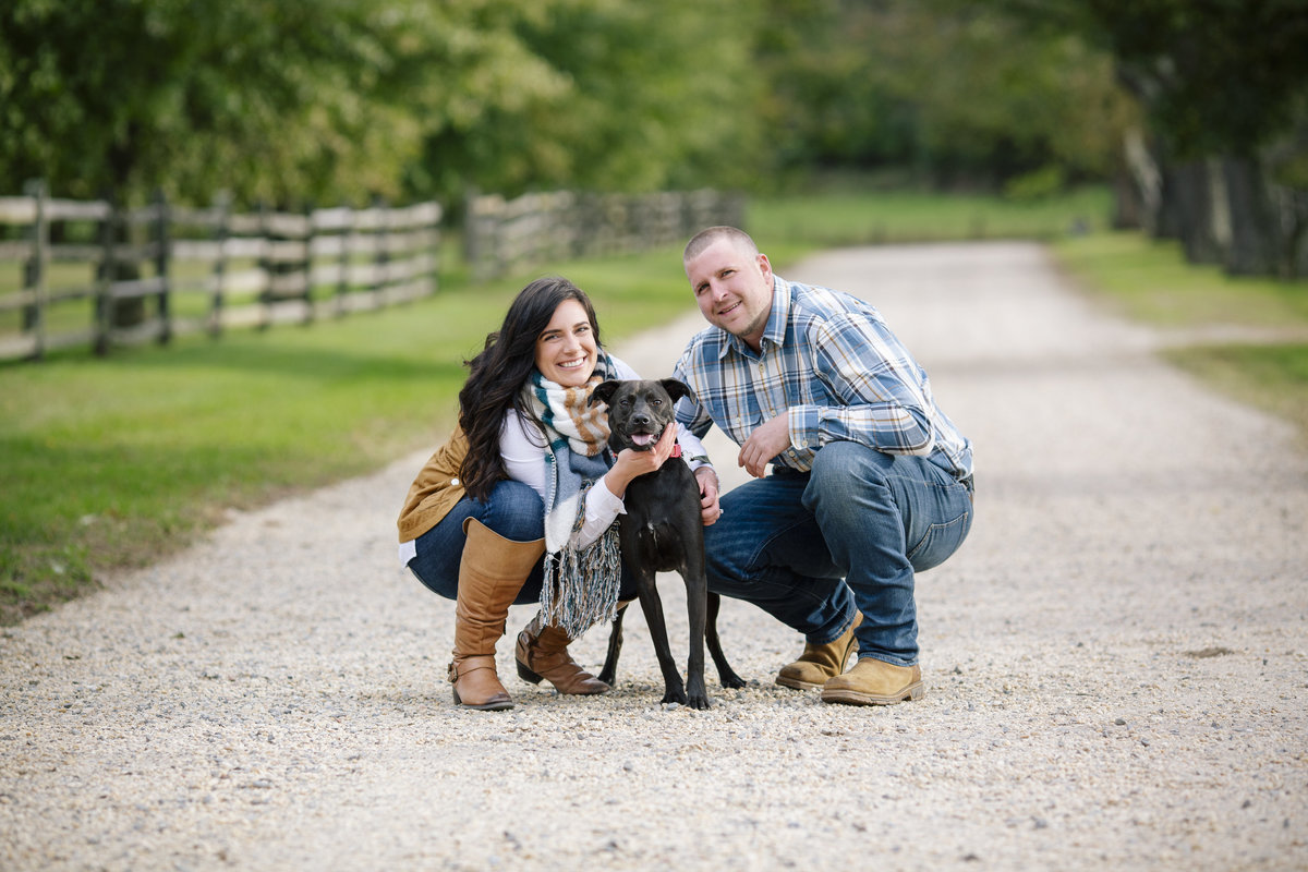 engaged couple with their dog on path in bayonet farm