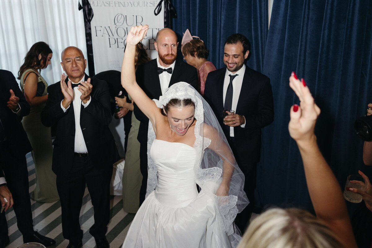 Bride leading a group dance during fun-filled wedding reception

