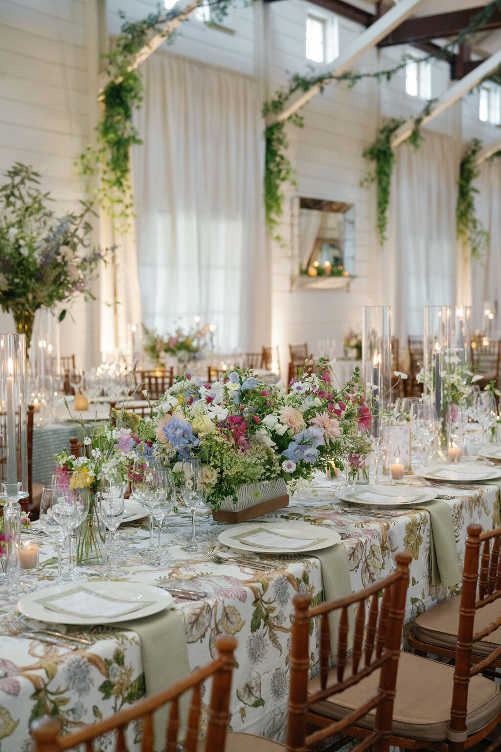 wedding tables with english garden style florals and floral linen in pippin hill granary