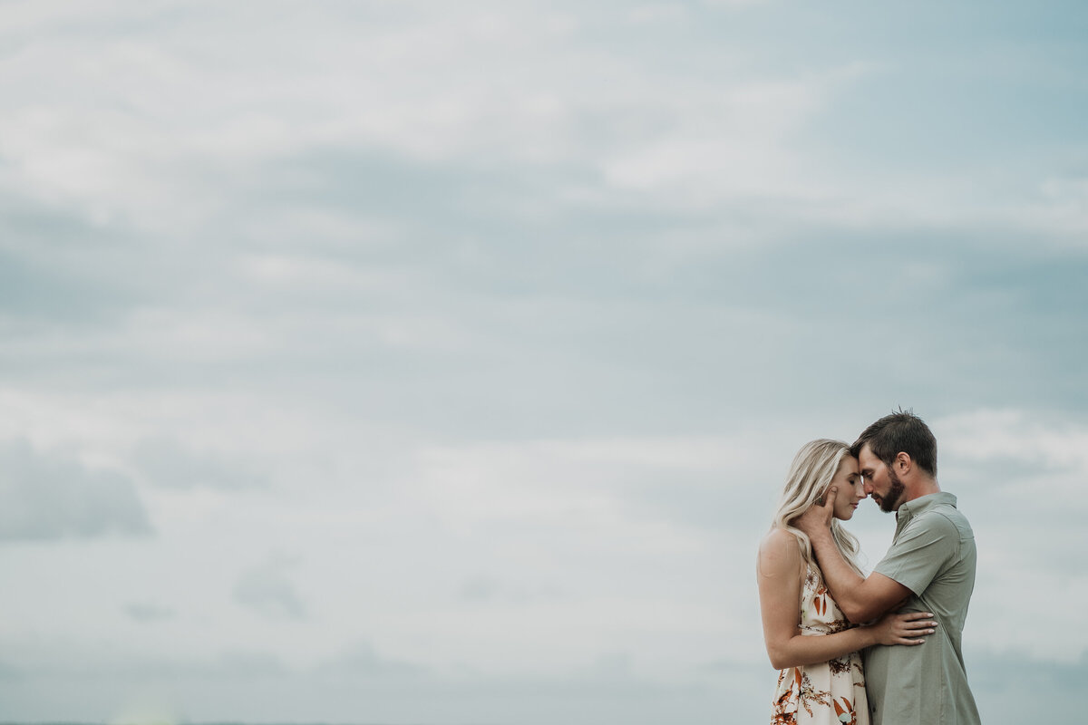 couple hugging with sky on the background