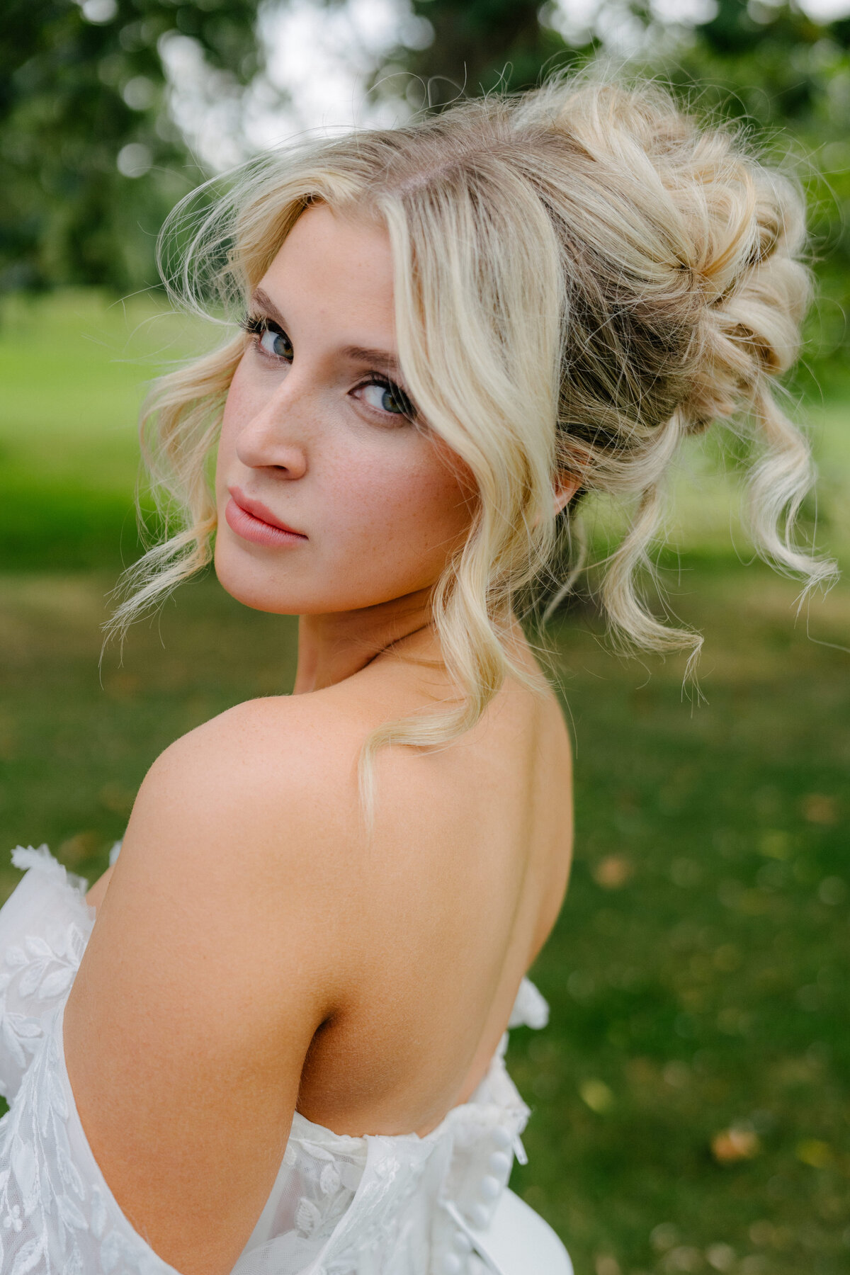 Bride with textured updo and natural bridal makeup in Chicago, IL. Wedding hair and makeup services.