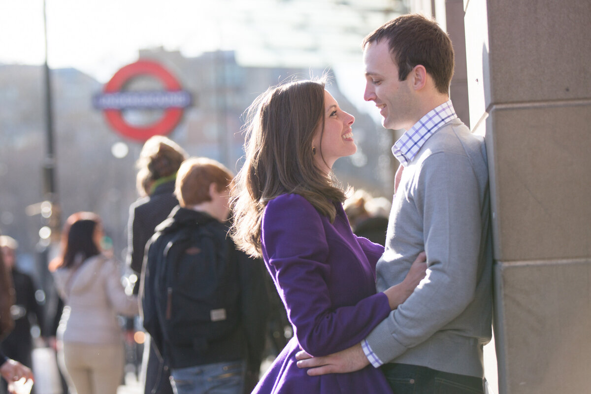 Couple embracing outside of tube station