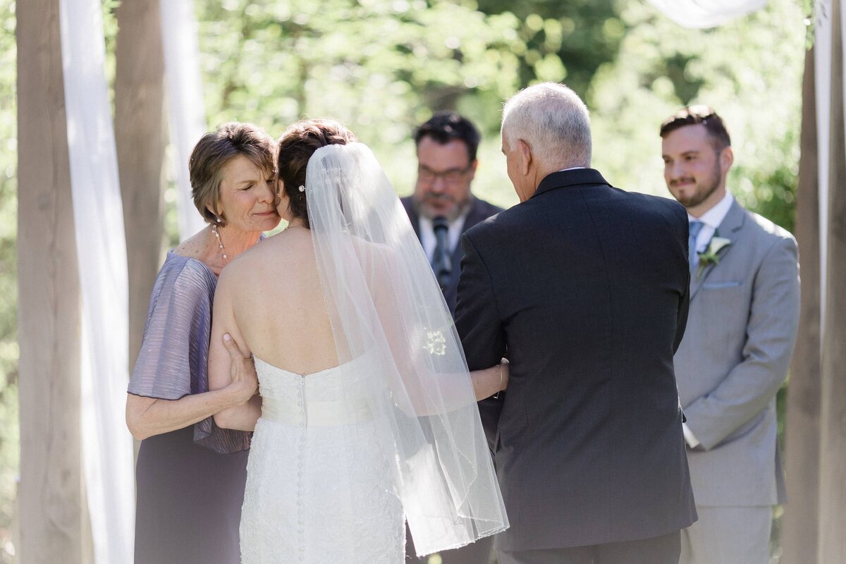 Emotional photograph of mother giving away her daughter during the ceremony at Anthony Wayne House