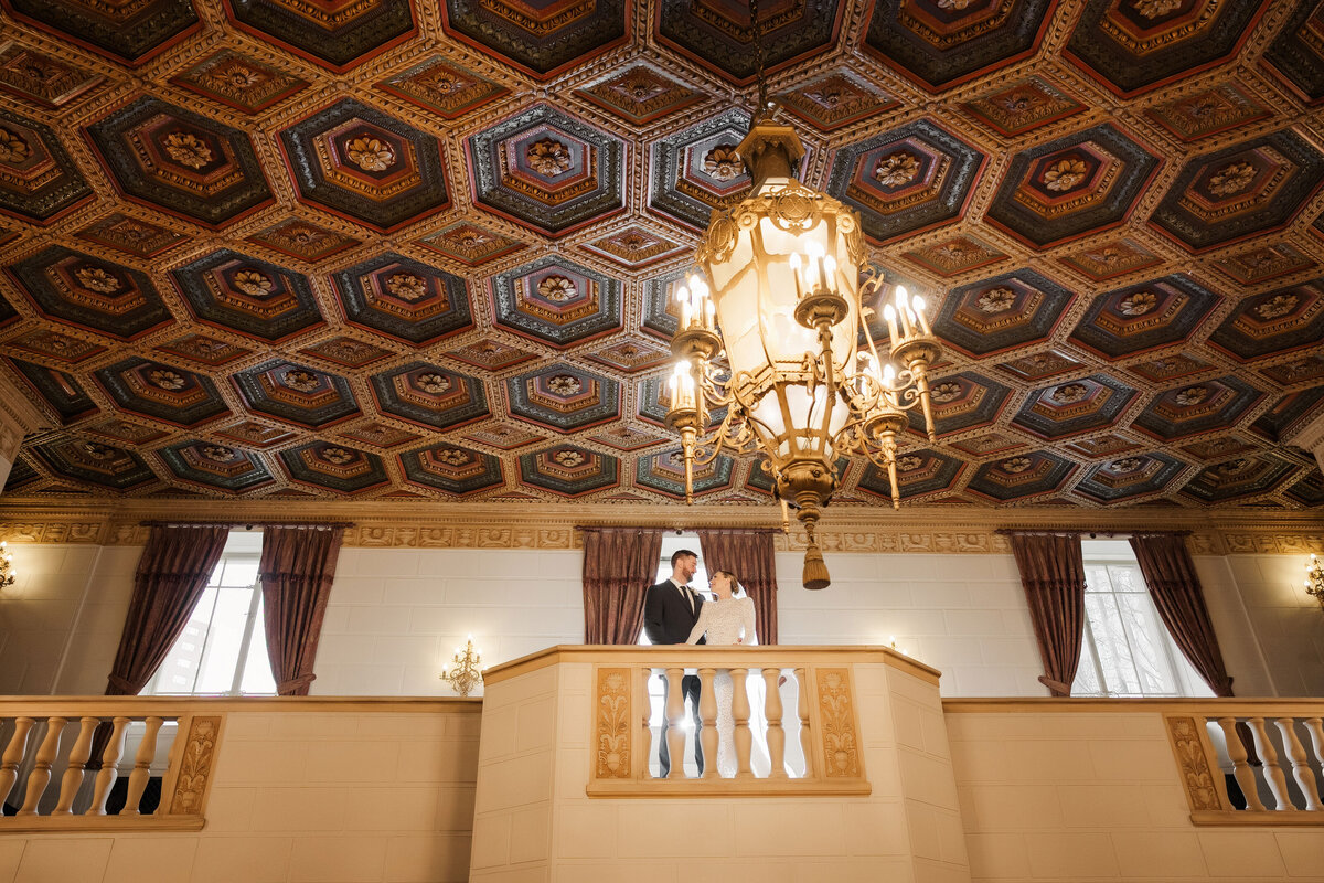 bride and groom on balcony at omni william penn