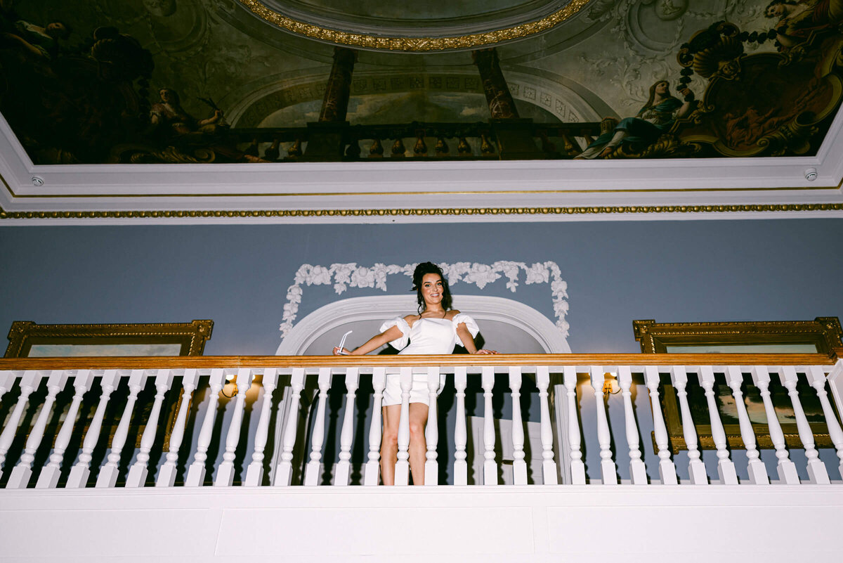 A wedding photo of a bride posing on the staircase at Luttrellstown Castle