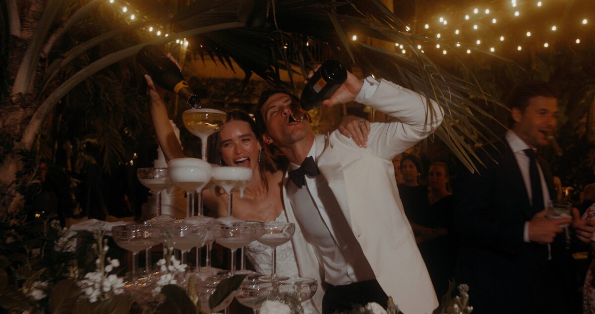 bride and groom drink and pour champagne
