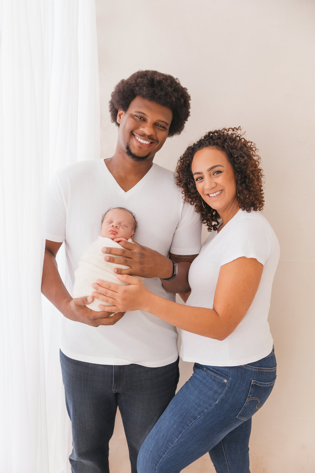 mom and dad holding baby during portrait session in phoenix