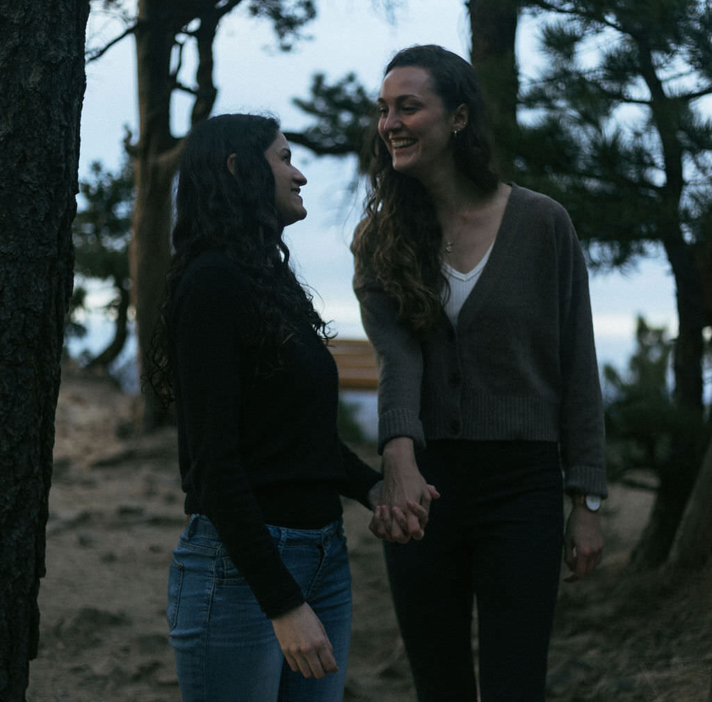 A couple holding hands and walking together.