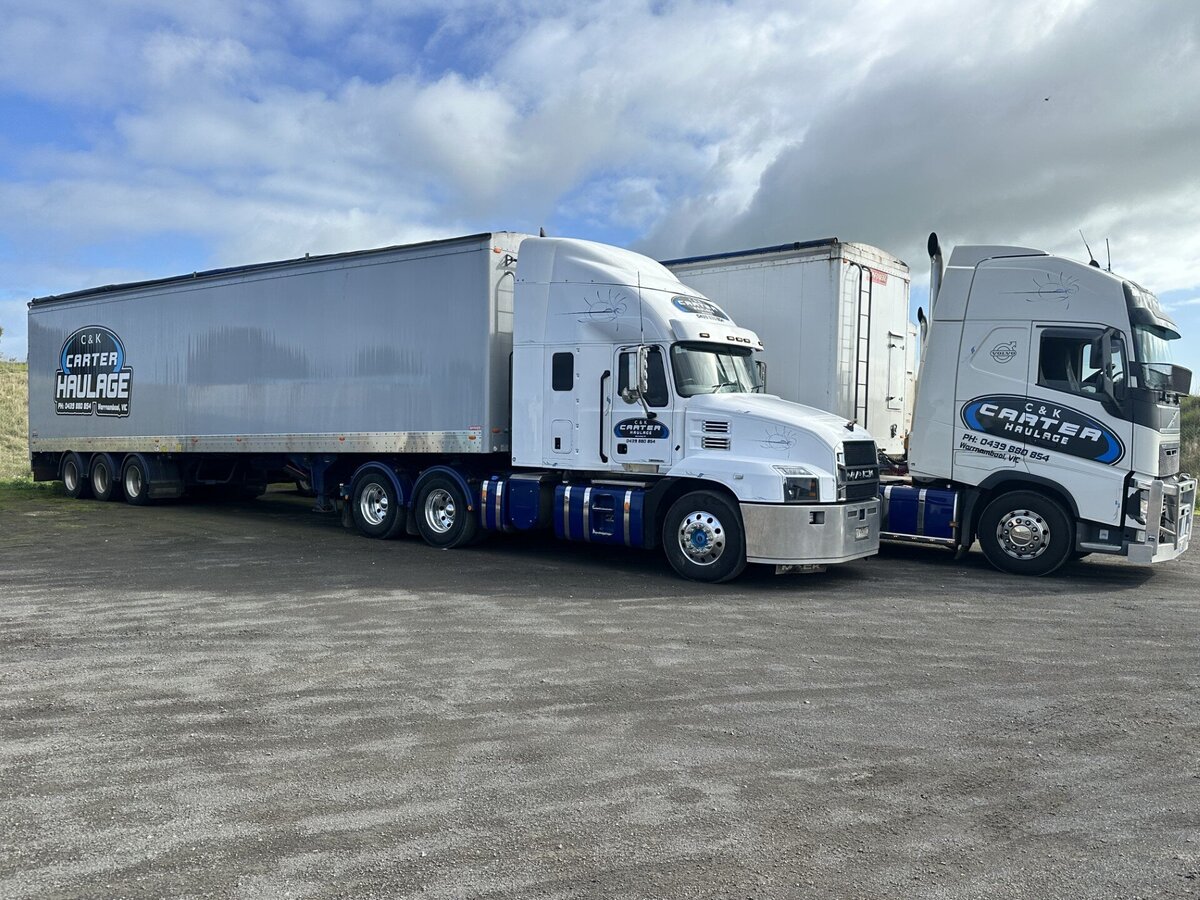Two trucks parked in waiting bay during transport
