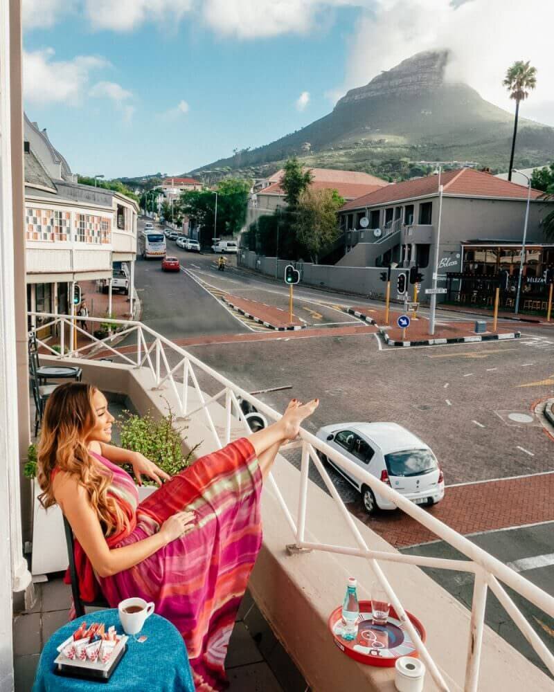 Isabella sitting on balcony - luxury travel blogger