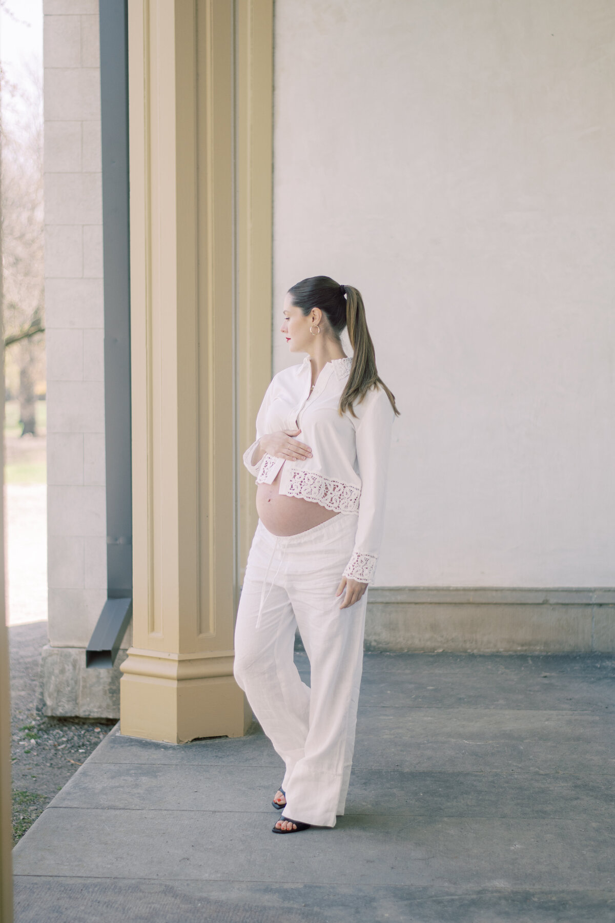 Cropped black-and-white maternity image highlighting a strong stance and serene expression in lace-trimmed Zara