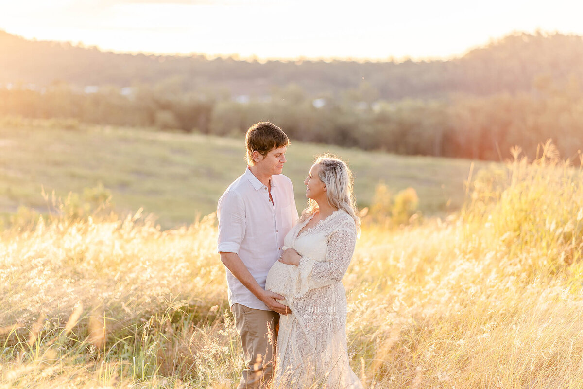 maternity photoshoot in golden grass during golden hours sunset in gold coast byron