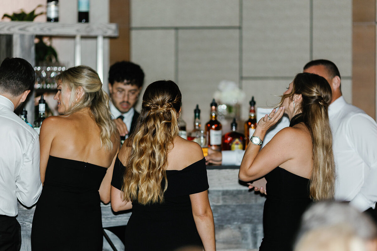 Wedding guests enjoying drinks at a stylish bar, captured during the celebration at Ocean Reef in Key Largo.