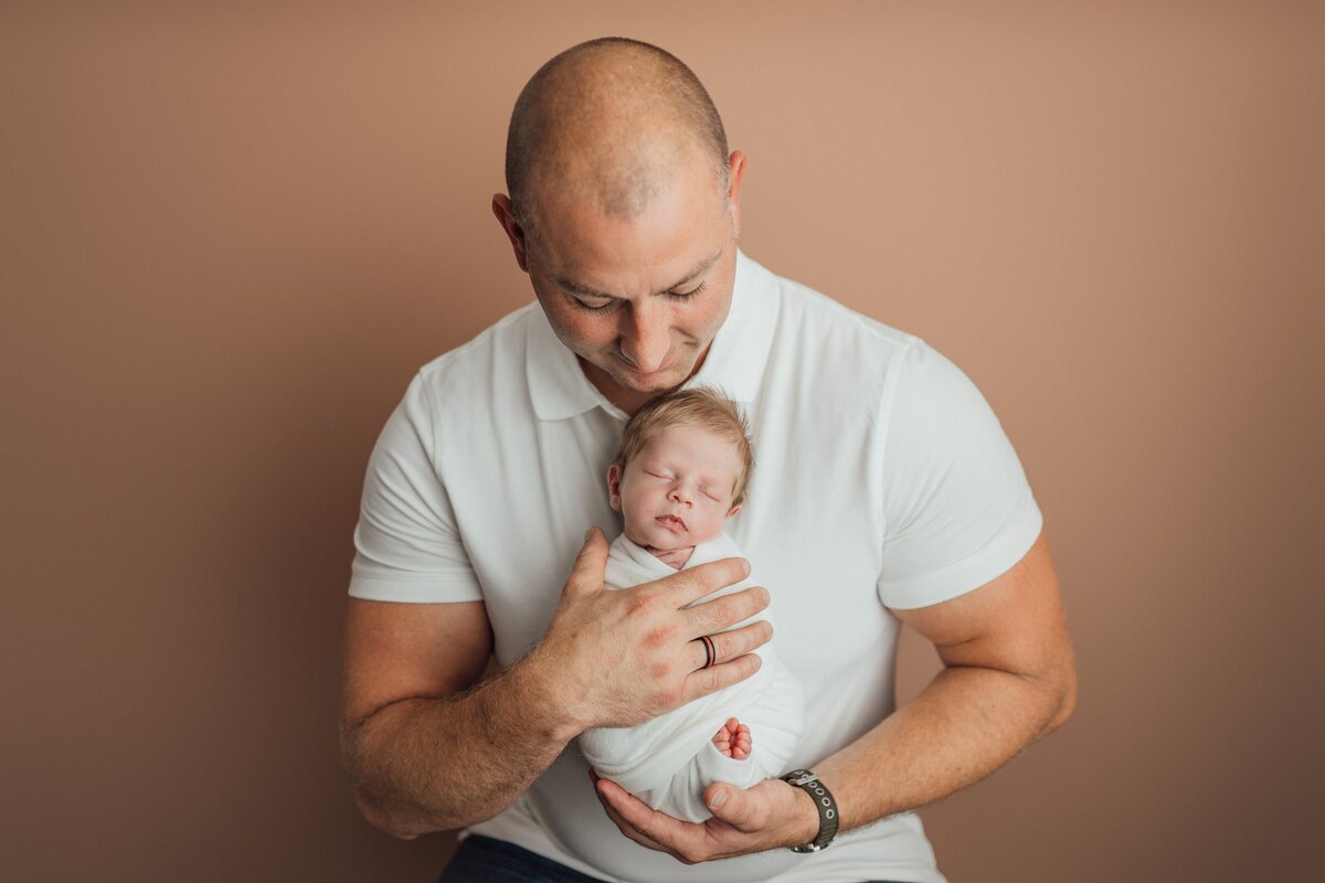 dad and baby during newborn photo session in tampa