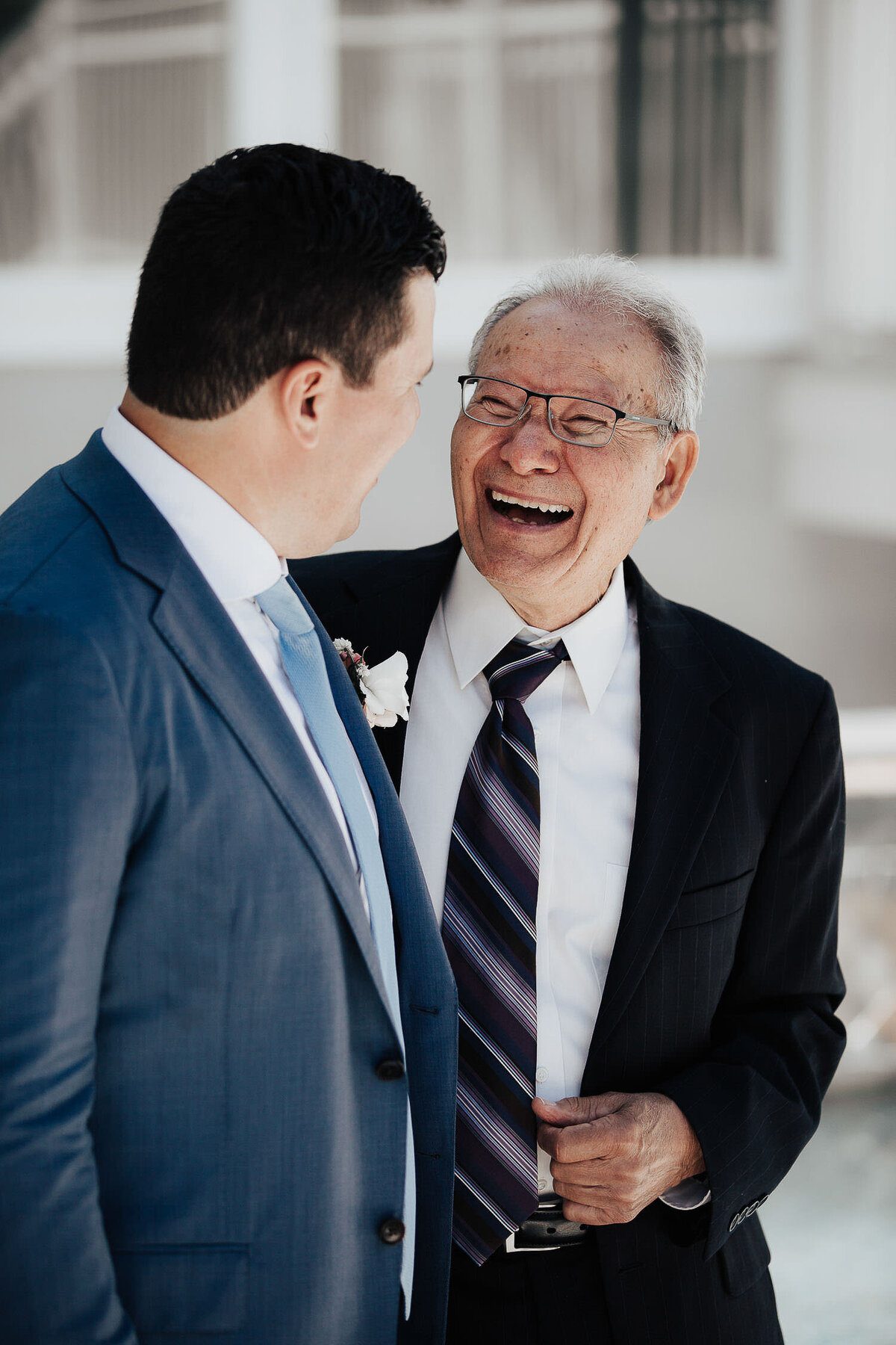 Happy Dad smiling at his son who got married