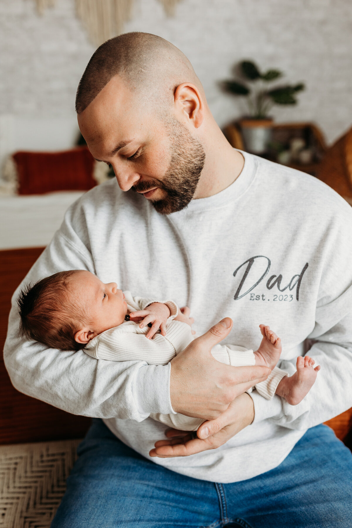 baby boy held by dad by harrisburg newborn photographer