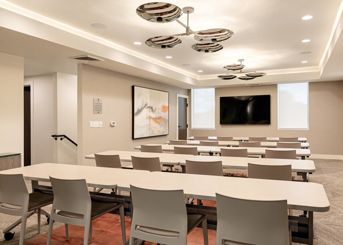 Wide shot of dental office classroom with accent carpet and plafyul artwork