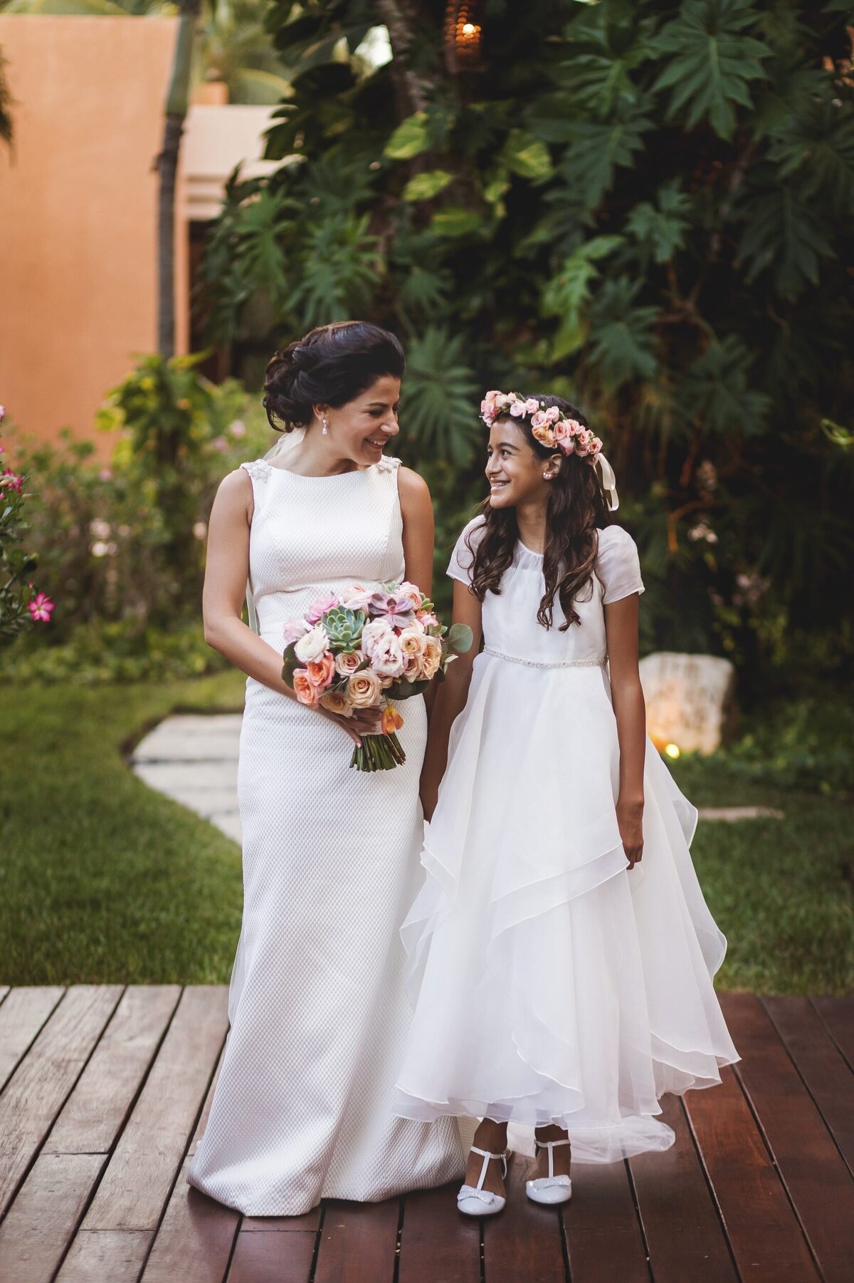 Bride with flower girl at wedding in Riviera Maya
