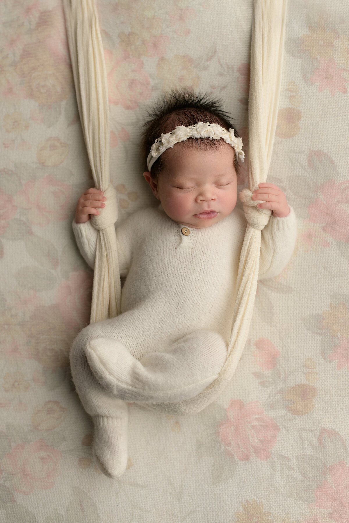 Newborn baby in white romper