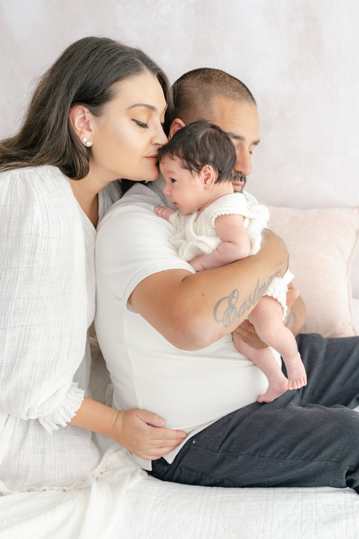 Family cuddling baby during natural light Barrie newborn photography session 