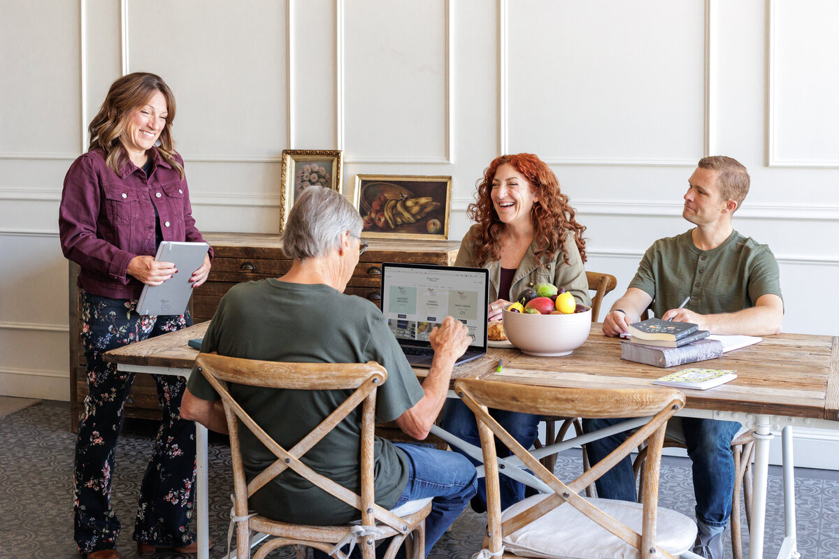 Women teaching a workshop to a group of adults