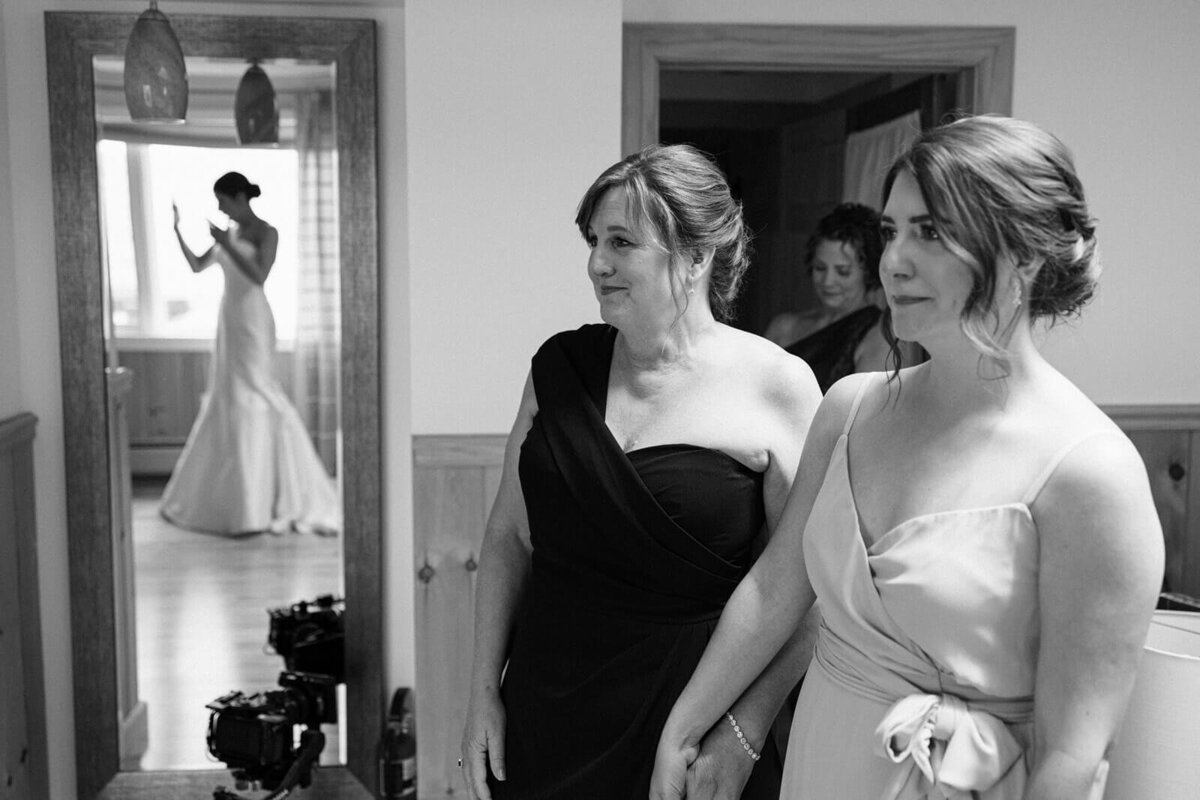 Bridesmaids looking at bride before wedding at Canandaigua Country Club, NY