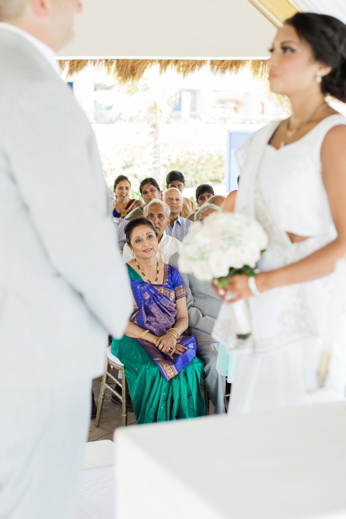 A tearful mother looks on as her daughter commits to her husband.  Photograph taken by Rebecca Cerasani
