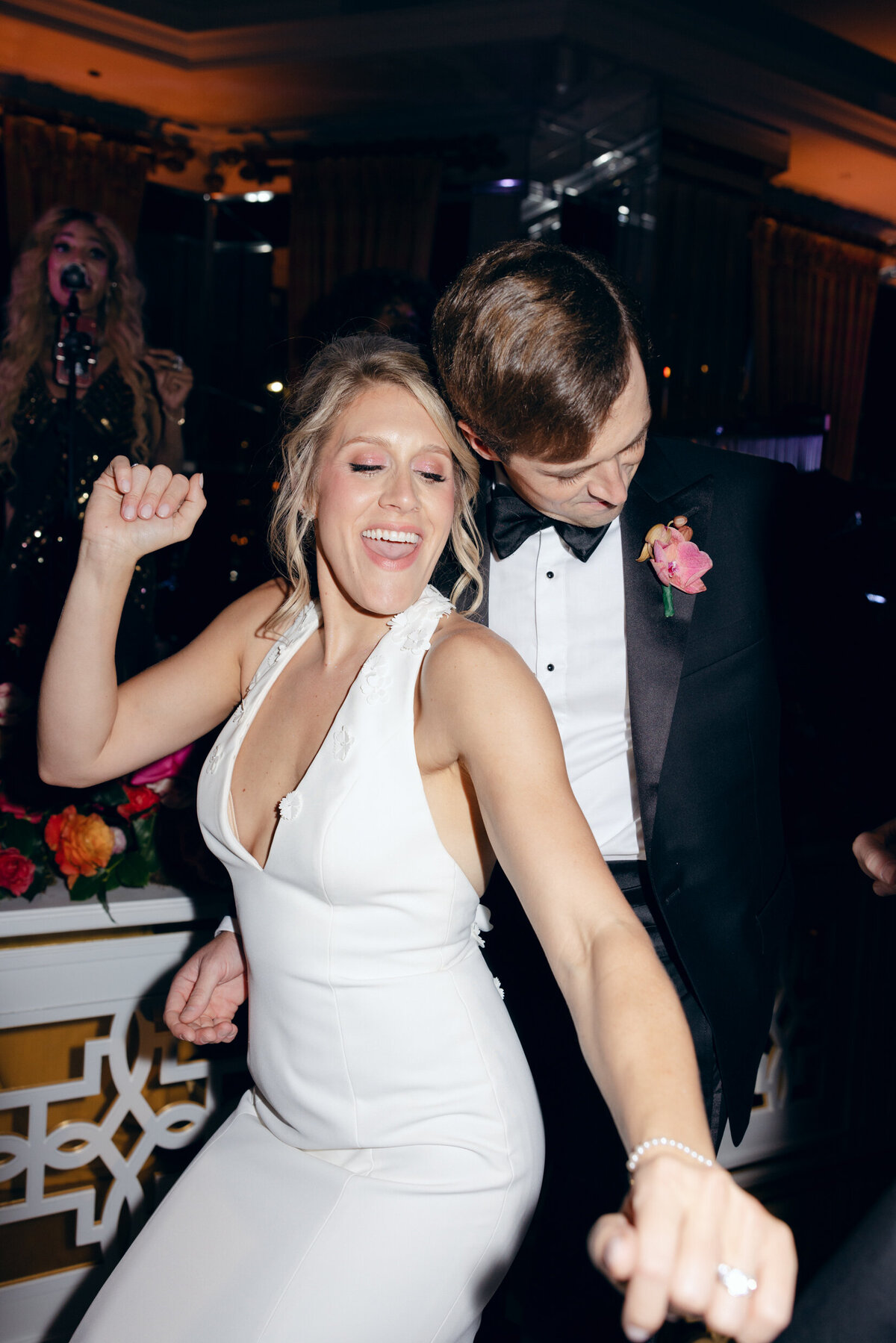 A candid wedding photo of the bride and groom dancing during their wedding reception