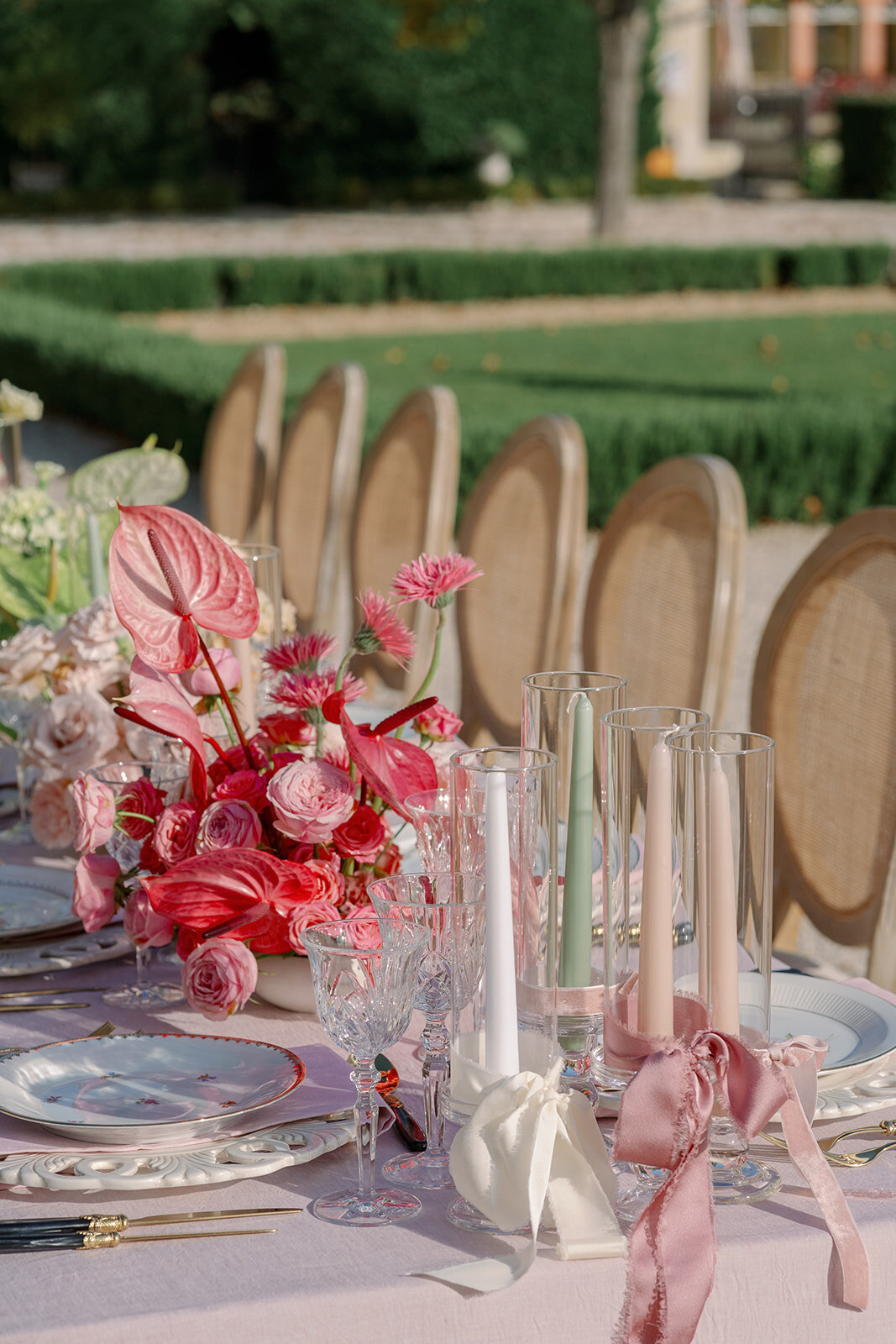 Luxury wedding tablescape with pink florals, neutral linens, and crystal glassware at Château de Tourreau.