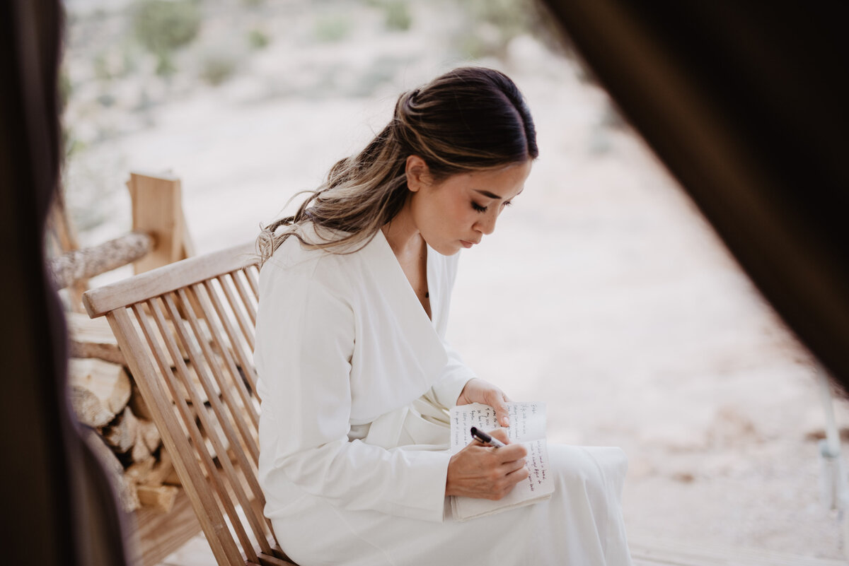 Utah Elopement Photographer captures bride writing in vow book