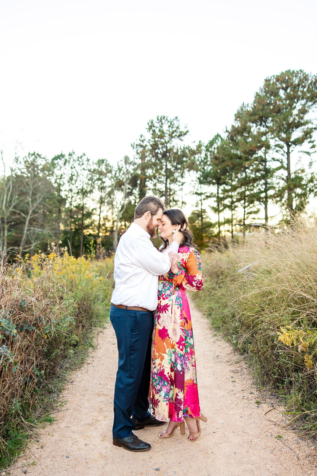 Engaged couple embracing on a dirt path
