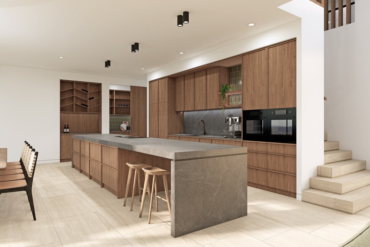 A spacious kitchen and dining area in Thalassa – Newport, featuring warm timber cabinetry, a large island bench with stone countertops, pendant lighting, and an integrated dining space.