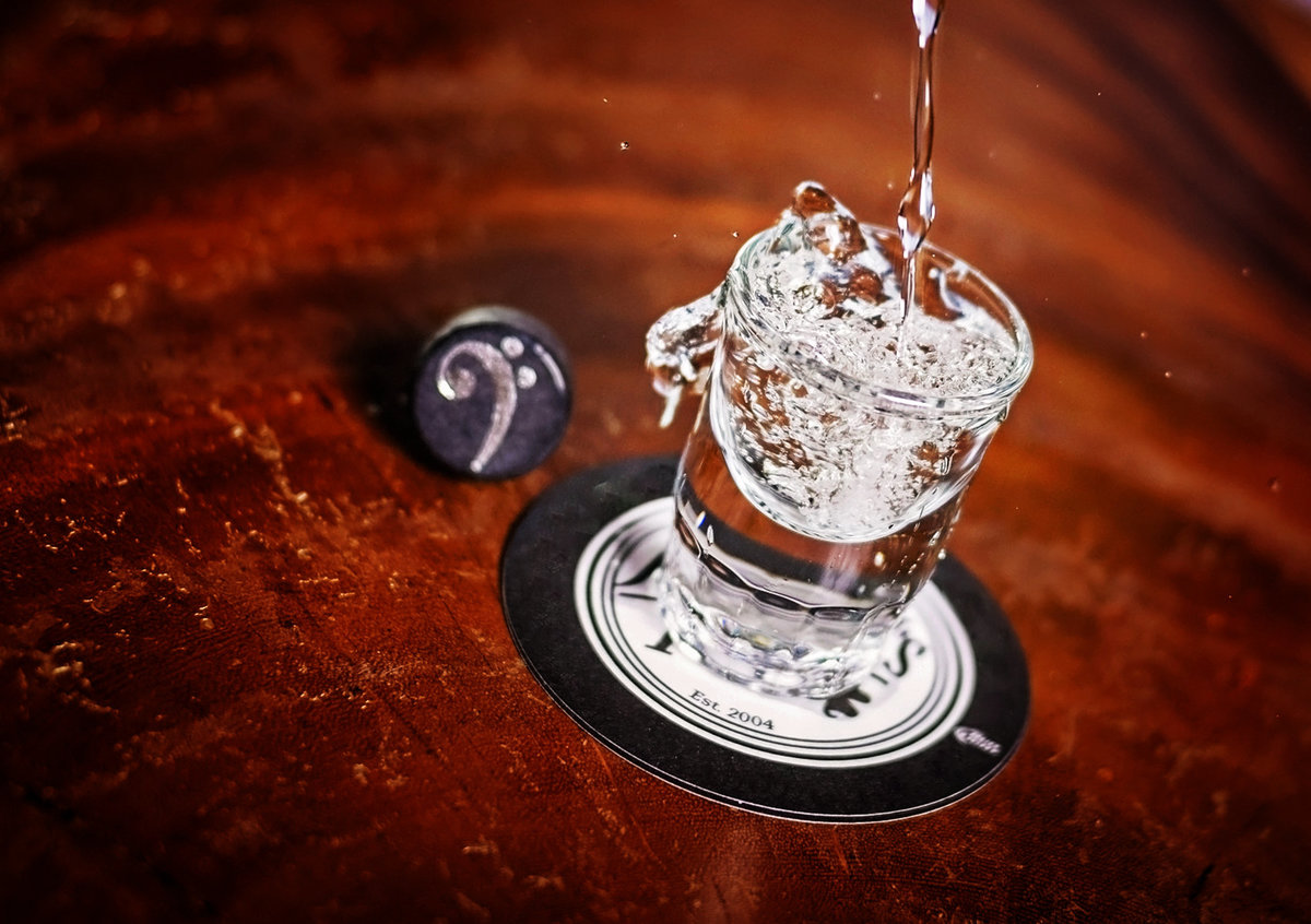 Advertising food photograph of pouring vodka
