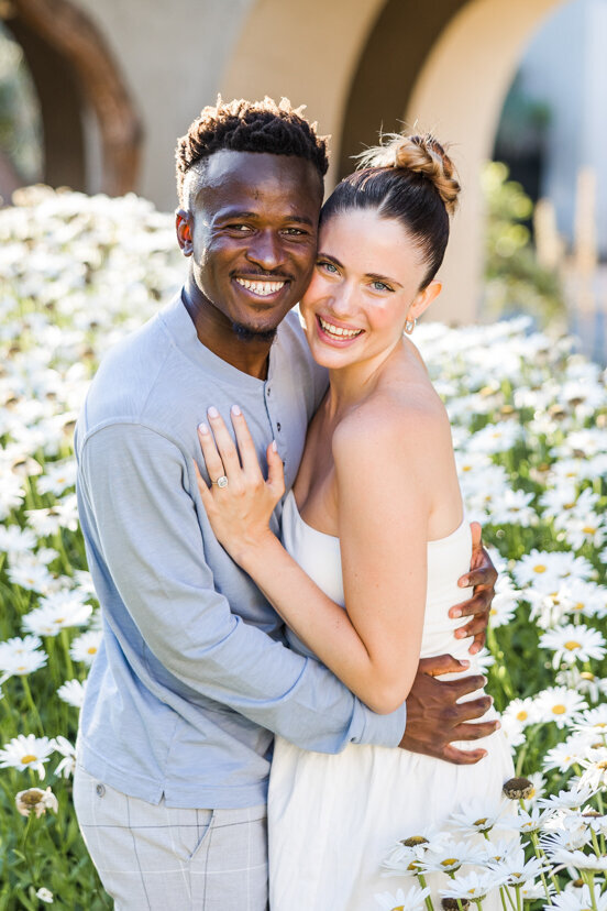 engaged-couple-in-white-daisies-balboa-park-san-diego