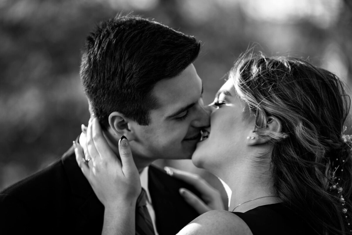 Dramatic black and white of couple kissing in the streets of Sewickley PA., caotured by Michael Fricke Photography, a Pittsburgh engagement Photographer