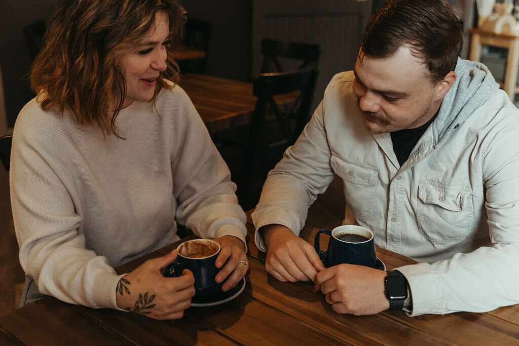 Candid photo of couple talking over coffee