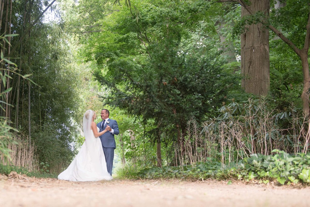 Bride and groom outside holding handing at Huntington Crescent Club