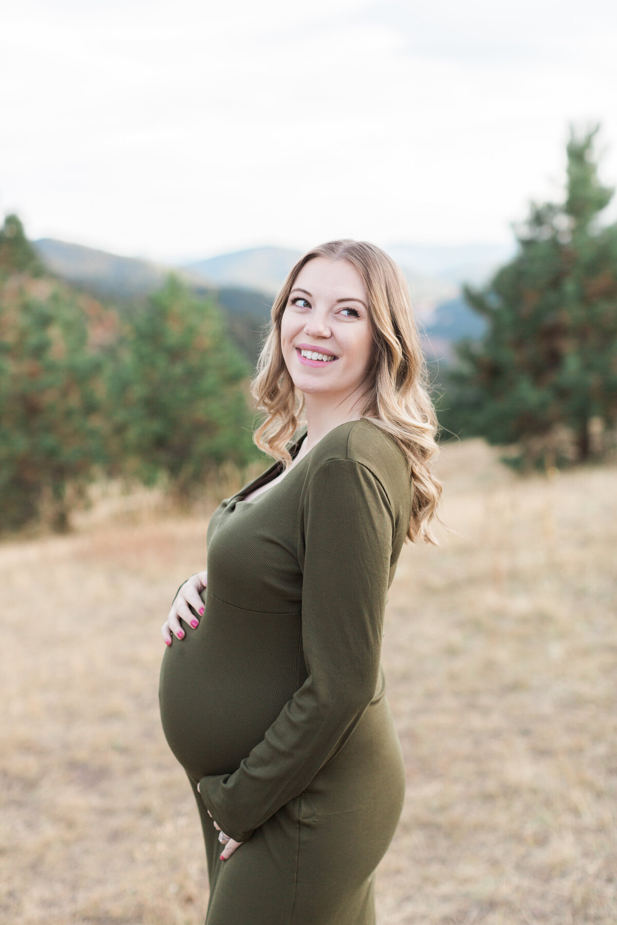A pregnant mother with a mountain view during her maternity session