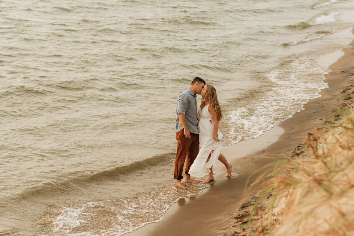 Engagement session kissing on beach South Bend