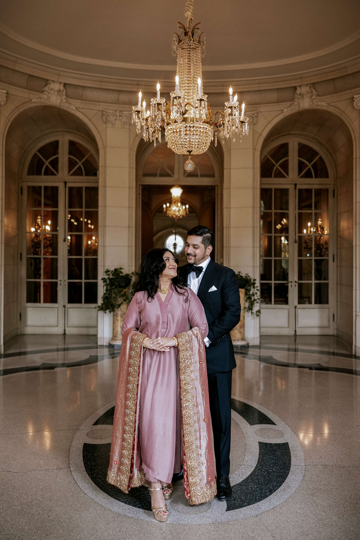 elegant-couple-posing-under-chandelier