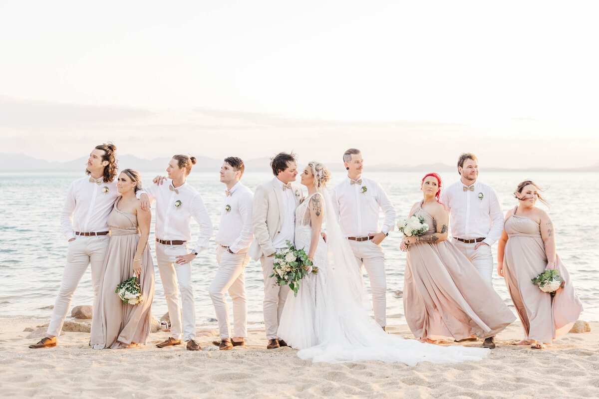 bridal party stand on whitsunday beach for portraits