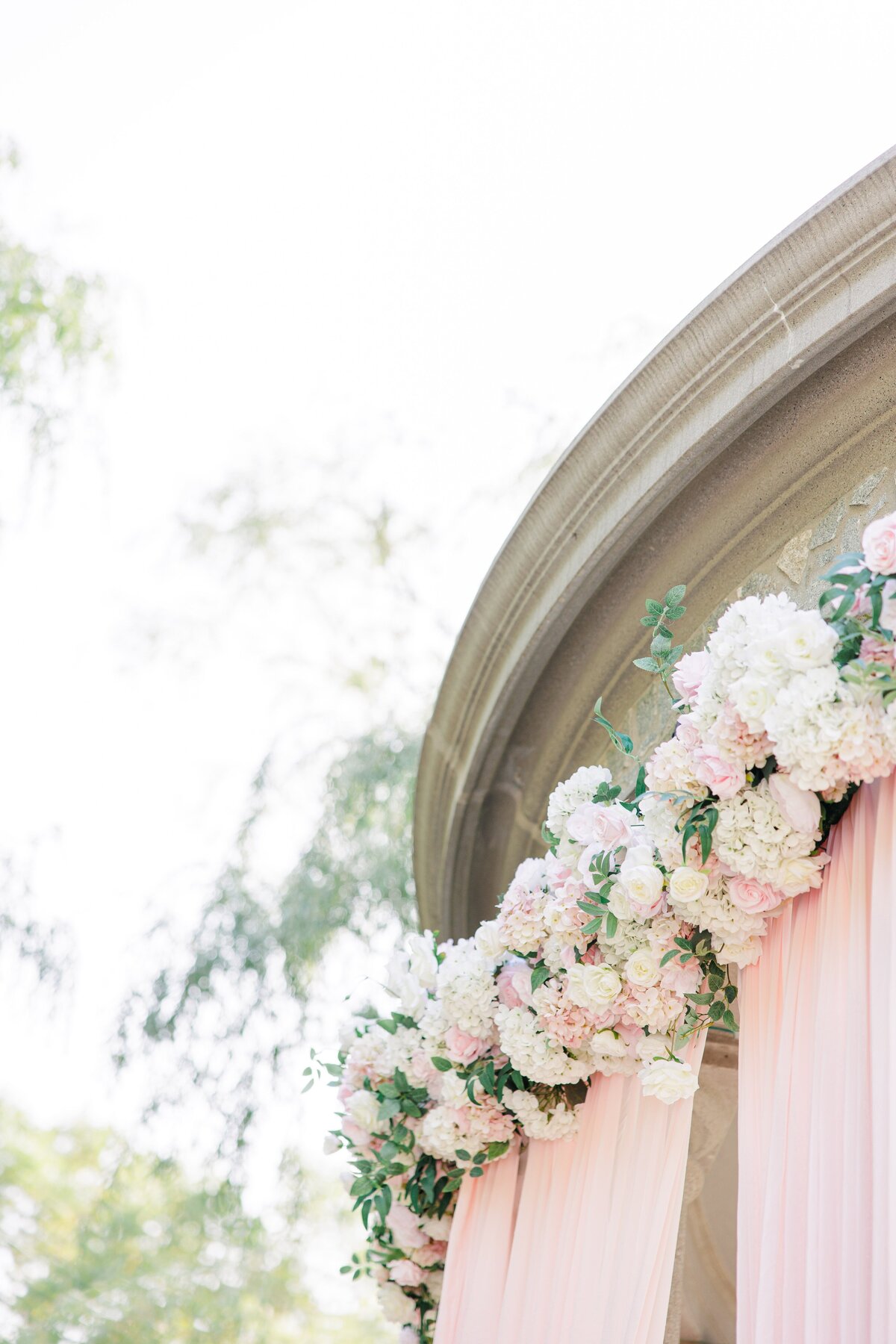 Wedding flowers and blush draping at Larz Anderson Park's tempietto