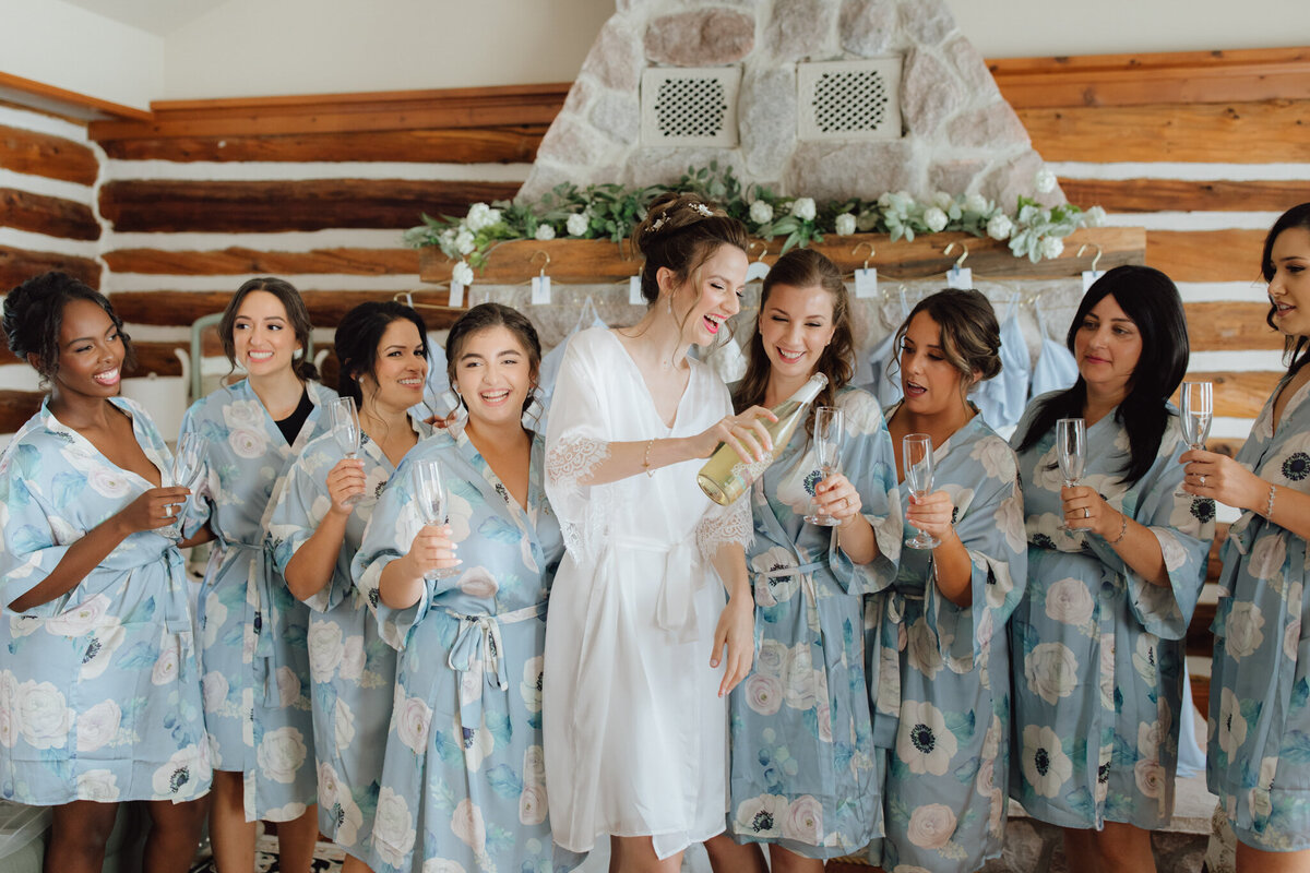 Bridal party wearing stylish blue bridal robes By Catalfo, elegant wedding fashion based in Kelowna. Featured on the Brontë Bride Vendor Guide.