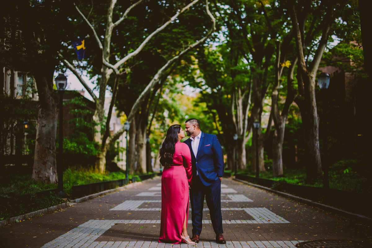 A couple sharing a moment wearing formal clothes on a brick walkway at upenn university of pennsylvania