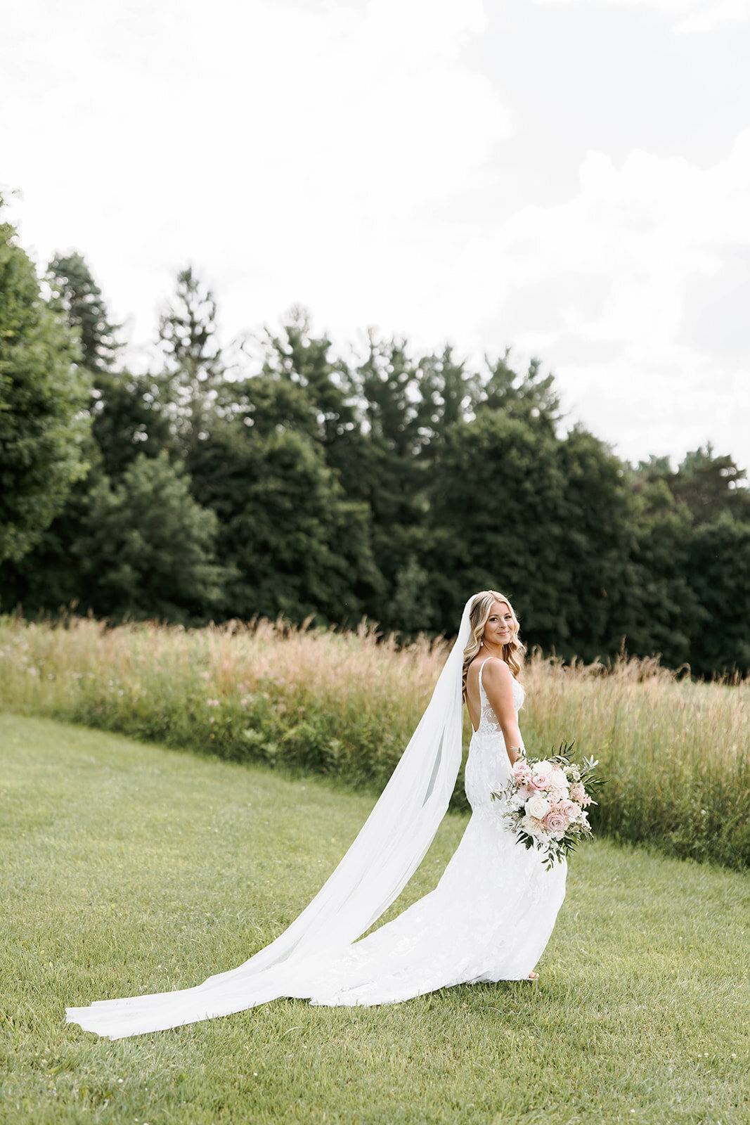 bride next to field in upstate new york for portraits