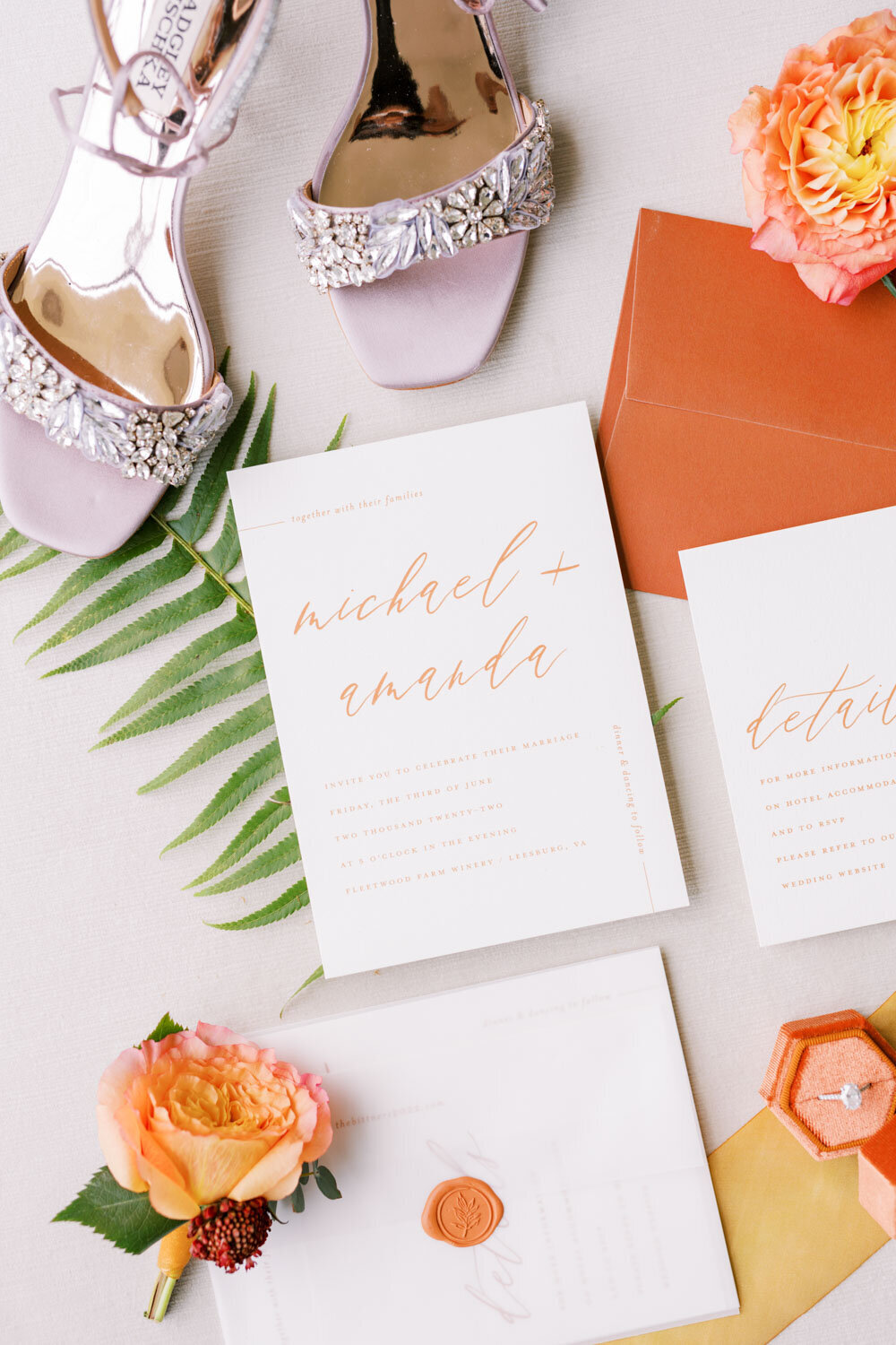 Flat lay of wedding invitations, wedding shoes and wedding ring