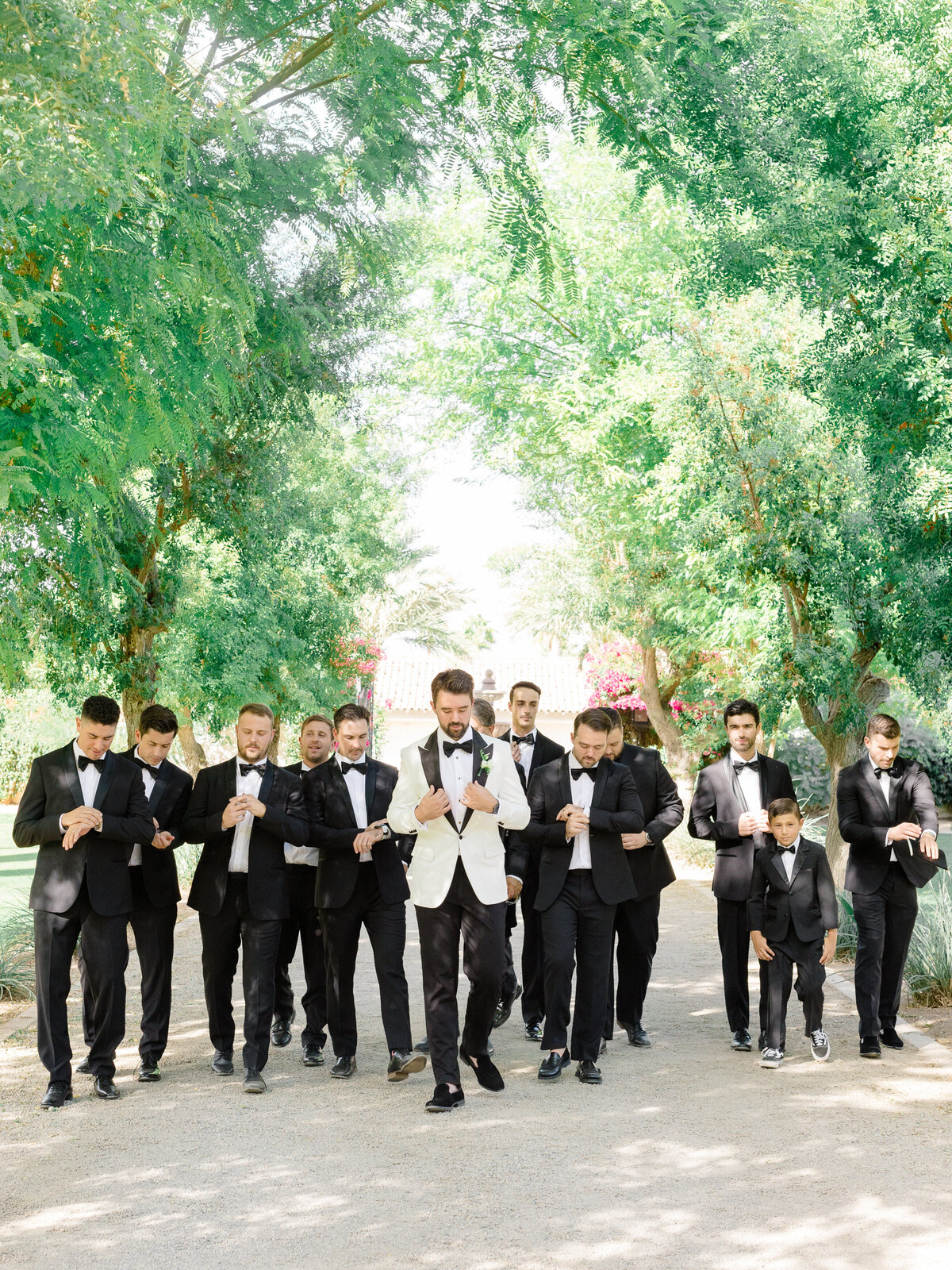 groom-groomsmen-walking-photo-black-tie-wedding-bougainvilla-estate-indio.jpg
