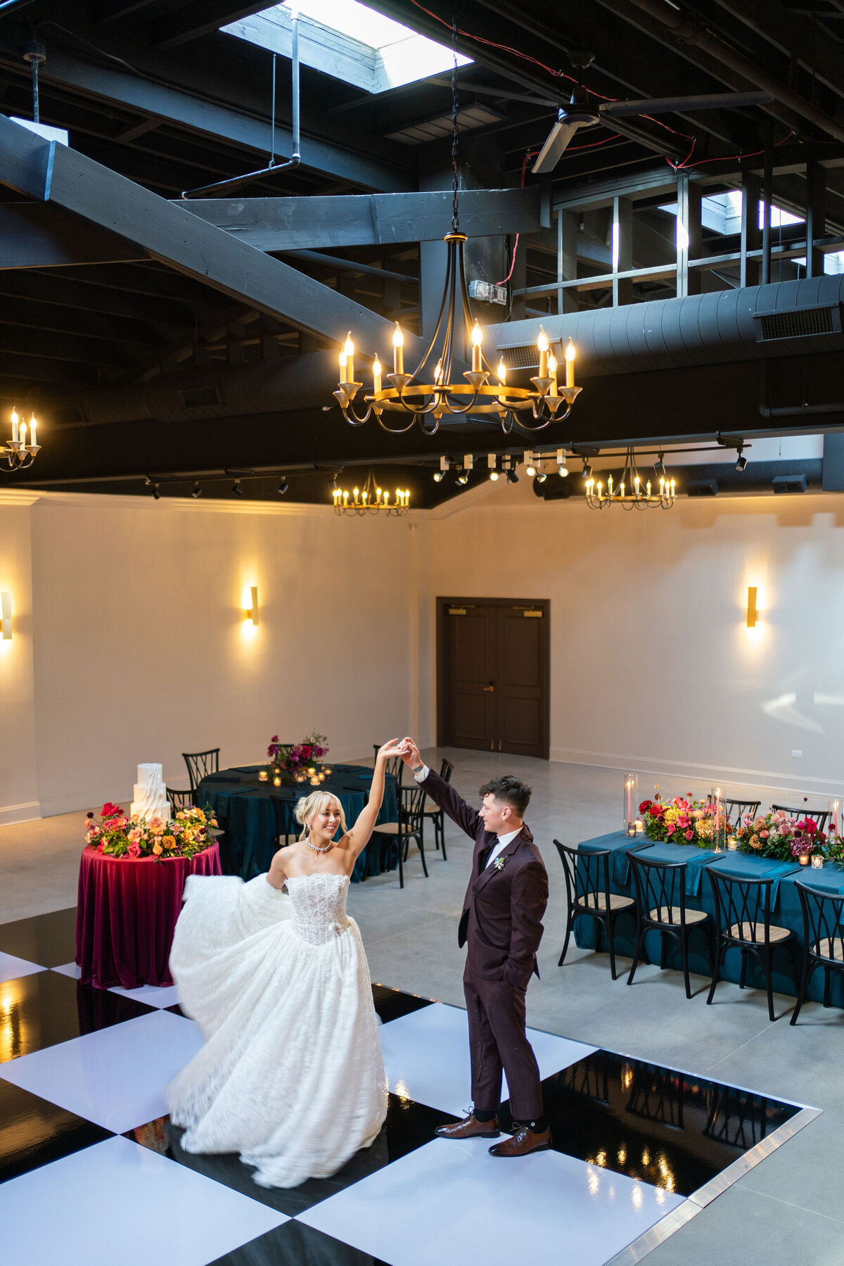 in house black and white dance floor in large reception space, timeless space with personalized floral and design