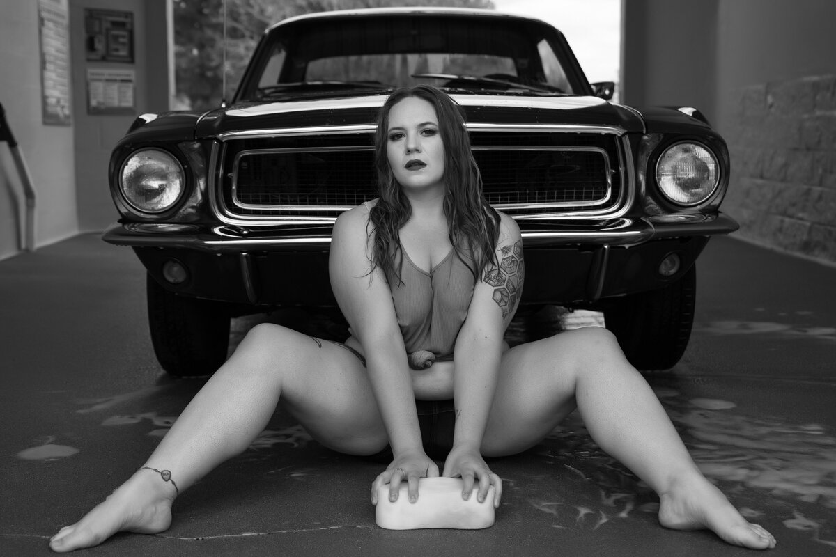 Woman posed with a classic Ford Mustang for sexy car wash photo shoot
