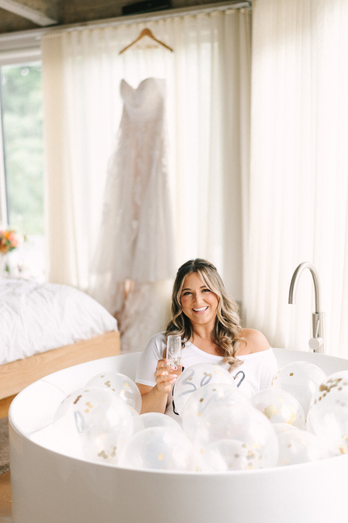 bride relaxing in tub before getting wedding dress on